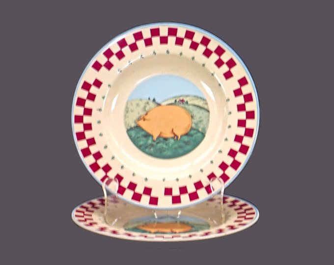 Pair of Tienshan Folk Art stoneware salad plates. Plump pink pig in center, red checked rim, blue trim.