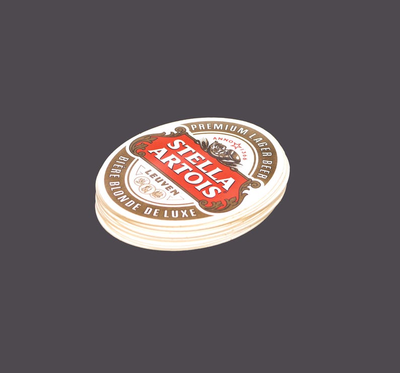 Twelve Stella Artois Biere Blonde Deluxe Oval Cardboard Coasters. Great