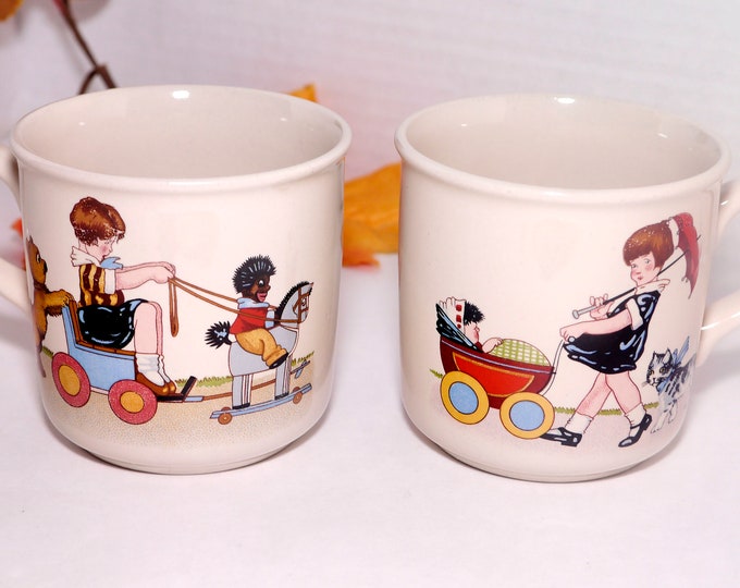 Pair of vintage (1980s) Die Spiegelburg children's handled mugs. Walking the Baby, Rocking Horse. Made in Germany.
