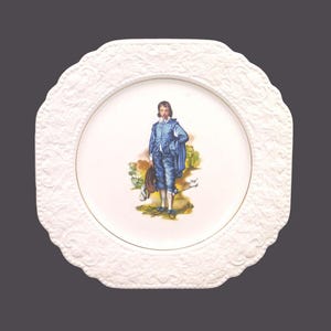 May include: White ceramic plate with an embossed design. The centre of the plate features a colourful illustration of a man in a blue suit holding a hat. The text "John Boye" and "Doncaster" is printed below the illustration.