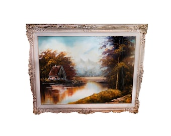 Attributed mid century original oil on canvas painting signed Lamont. Elaborate carved grey wood frame. Forest, river, cabin landscape.