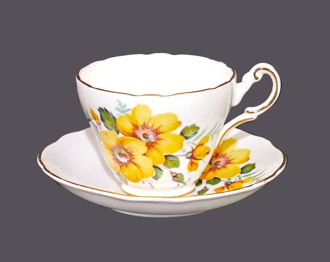 Grosvenor China cup and saucer set made in England. Yellow pansies, gold edge.