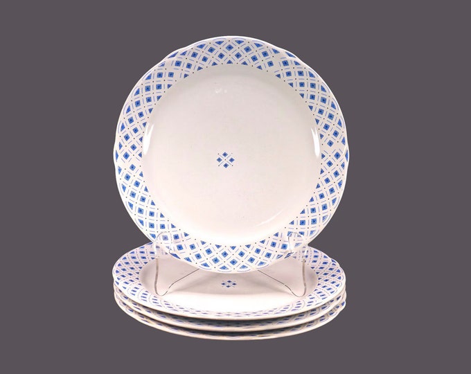 Four Royal Oak blue-and-white large dinner plates. Blue diamonds | triangles and black stars on white.