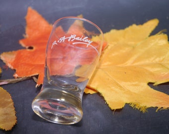 Baileys Irish Creme single shot glass. Etched-glass R.A. Bailey signature in white.