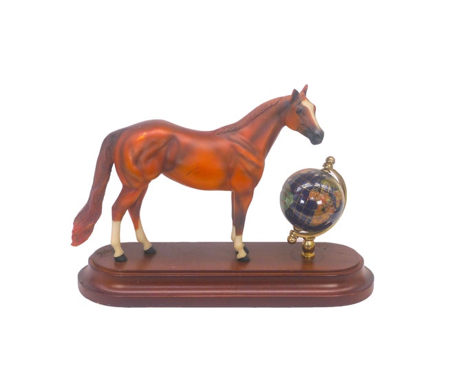 Ceramic horse figurine on wood base. Murano rotating world globe.