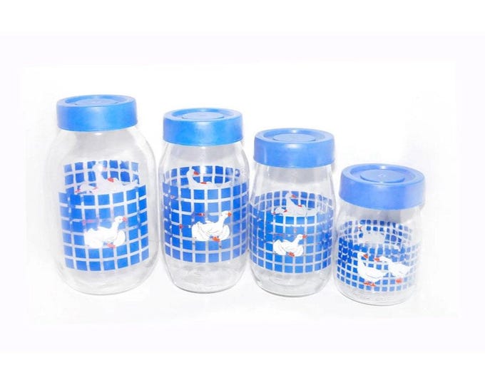 Four Carlton Glass Marmalade white geese blue checks canisters with removable blue plastic lids.