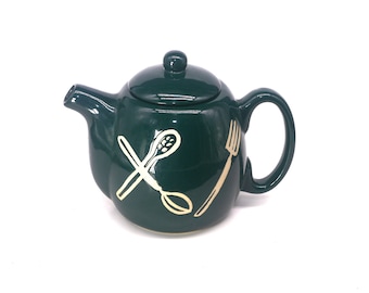 Six-cup teapot or coffee pot. Dark green with images of kitchen utensils.