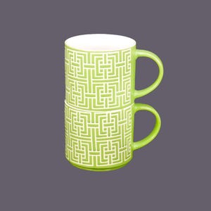 Retro vintage lime green coffee or tea mugs. High-relief geometric motif in white.