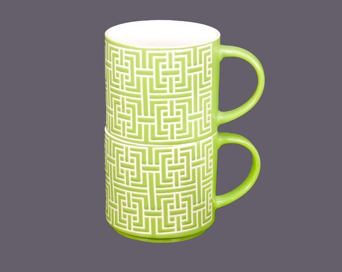 Pair of retro lime green coffee or tea mugs. High-relief geometric motif in white.