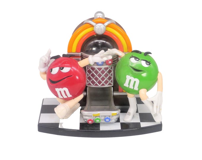 M&Ms Juke Box candy dispenser. Mr. Red and Ms. Green in her go-go boots dancing it out. Too cute.