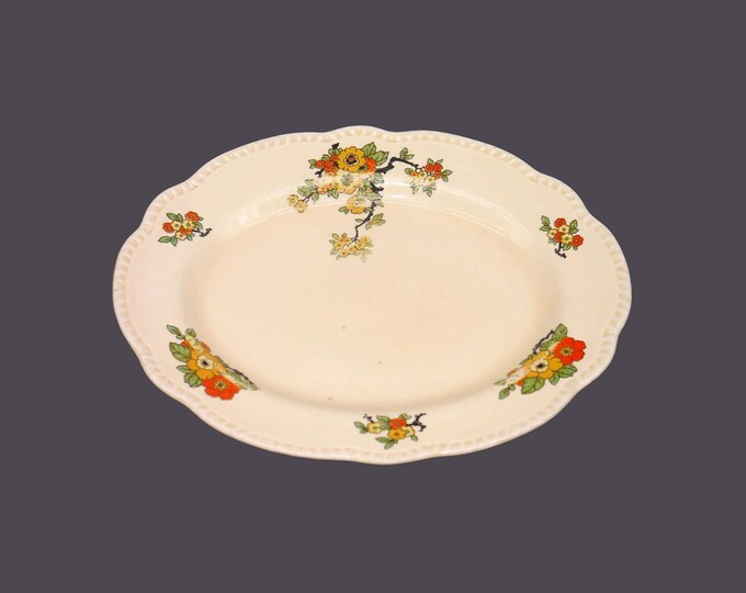 William Wood & Co. W1231 759778 oval platter made in England. Orange red yellow flowers, embossed edge. Flaw (see below).