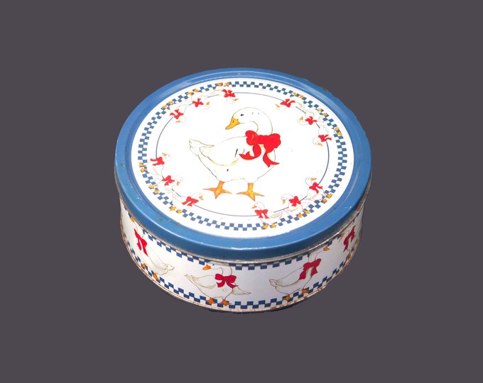 Round cookie tin. White geese, red ribbons, blue checks. American Trends Corp.