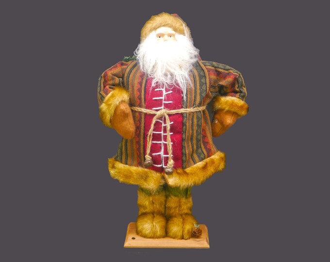 Tall Bobble-head Santa Claus figurine with fur boots, fur-trimmed jacket and burlap sack on wooden stand.