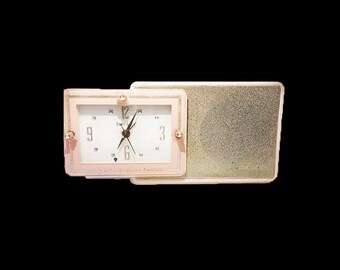 Mid century (1957) Bulova Princess Pink Model 110 pink AM clock radio with night light.