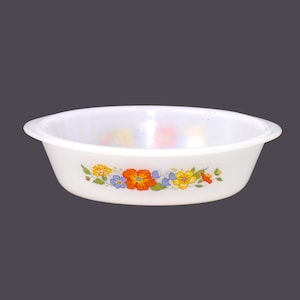 May include: White oval baking dish with a floral design in shades of orange, yellow, blue, and green.