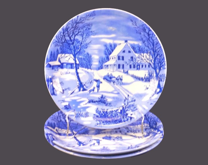Three Currier & Ives blue-and-white Christmas salad plates.