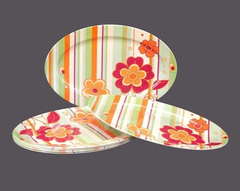 Six Melaware flower-power melamine burger or steak platters. Orange, yellow, red flowers and orange and green stripes.