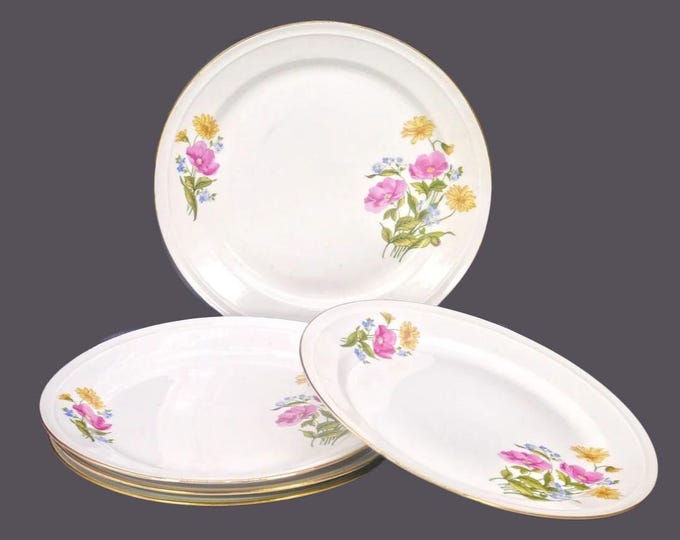 Five Freiberger Porzellan luncheon plates made in Germany. Pink, blue, yellow florals, gold edge. Flaws (see below).