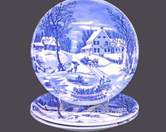 Three Currier & Ives large, blue-and-white Christmas dinner plates.