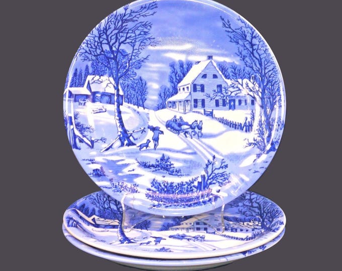 Three Currier & Ives large, blue-and-white Christmas dinner plates.