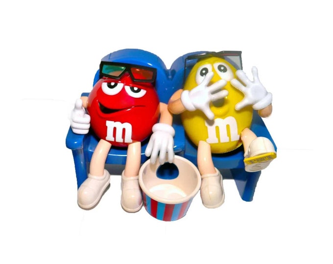 M&Ms At the Movies candy dispenser. Mr. Red and Mr. Yellow with popcorn bowl at a scary 3D movie. Too cute.