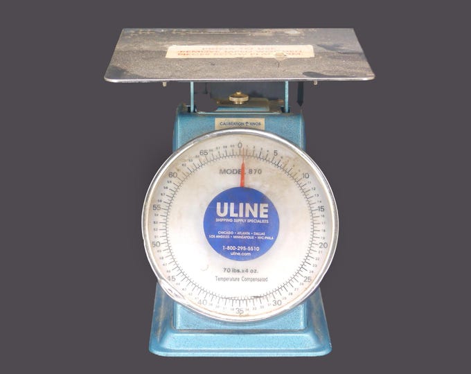 Uline 870 metal parcel weighing scale with calibration knob made in Taiwan. Handles up to 70 lbs.