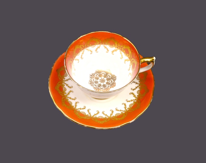 Aynsley 2331 bone china cup and saucer set made in England. Salmon, gold medallion center.