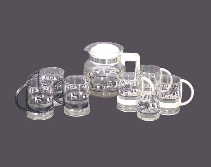 Nine-piece glass coffee service. Black-and-white cows. Coffee pot with lid, 6 handled cups, tumbler.
