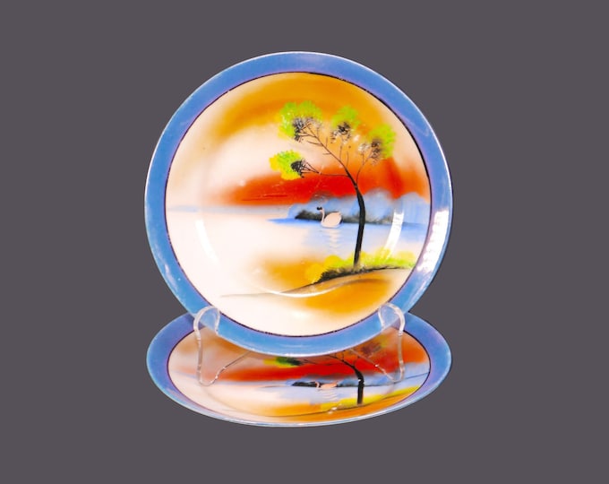 Pair of Chikaramachi hand-painted Nippon CHK21 lusterware dessert plates. Swan Lake theme, blue luster rim.
