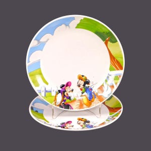 Pair of Gibson Designs GID378 Disney Mickey and Minnie Mouse dinner plates. A duck bites a hole in Mickey's trousers.