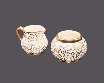 Sudlow's 0657 creamer and open sugar bowl. Gold squiggle pattern. Made in England.