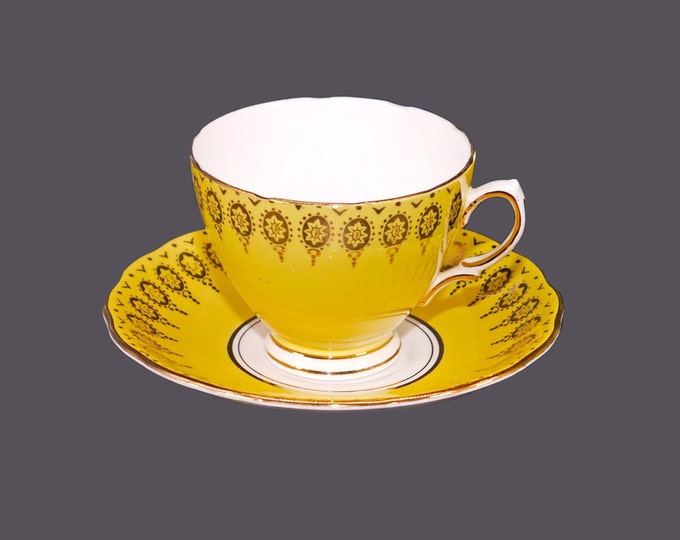 Colclough bone china cup and saucer set made in England. Sunny yellow with gold flowers and accents.