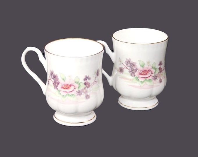 Pair of Crown Ceramics India bone china footed coffee | tea mugs. Pink and purple flowers, scalloped gold edge, accents.
