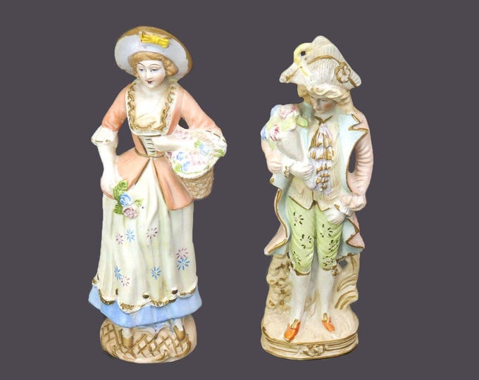 Pair of mid-century porcelain bisque figures. Man and woman in period dress. Made in Occupied Japan.