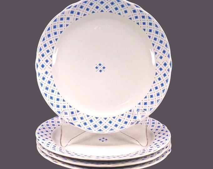 Four Royal Oak blue-and-white large dinner plates. Blue diamonds | triangles and black stars on white.