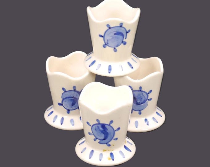 Four blue-and-white single egg cups. Hand-painted blue sun motif on white. Attributed to Portugal 1960s.