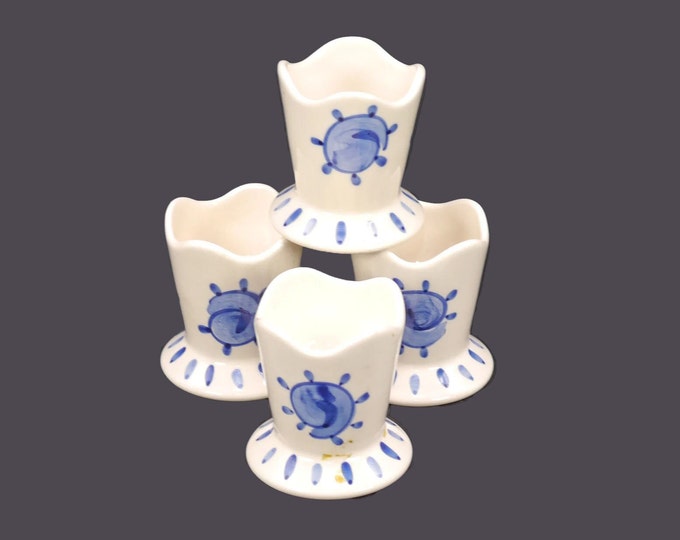Four blue-and-white single egg cups. Hand-painted blue sun motif on white. Attributed to Portugal 1960s.