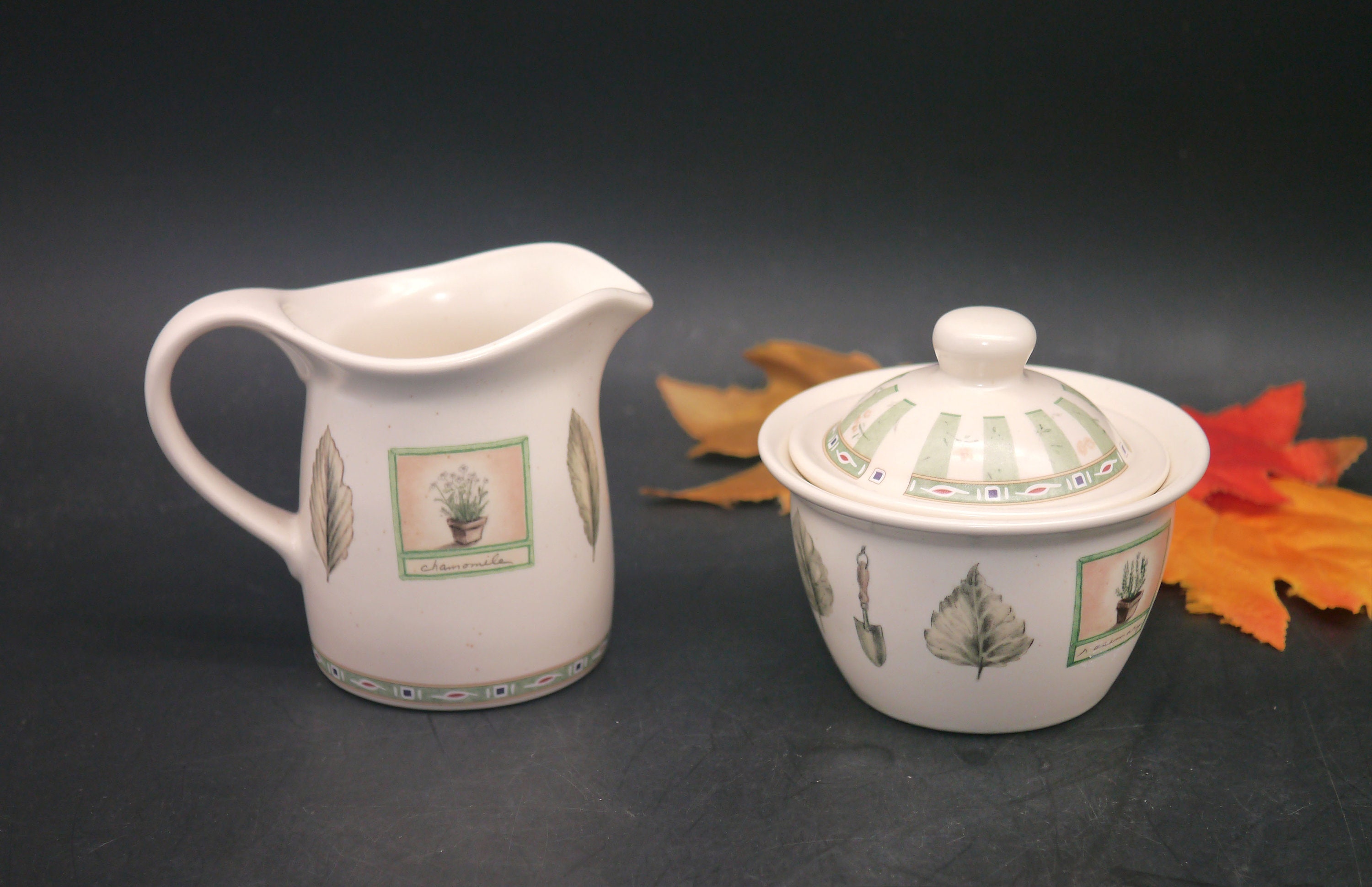 Pfaltzgraff Naturewood stoneware creamer and covered sugar bowl.
