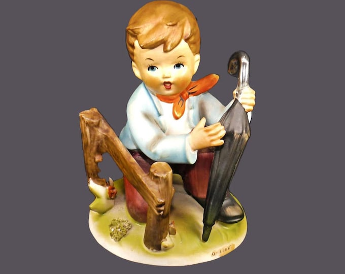 Erich Stauffer porcelain figurine S8517 Outing. Boy with umbrella kneeling by wooden fence made in Japan. Flaws (see below).