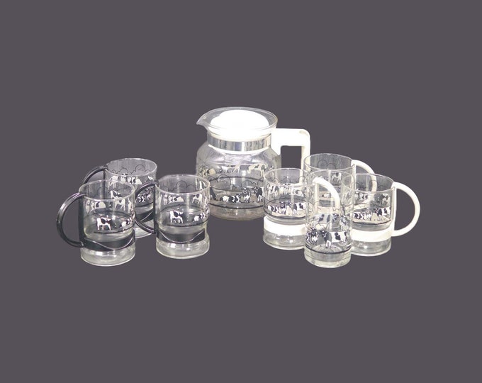 Nine-piece glass coffee service. Black-and-white cows. Coffee pot with lid, 6 handled cups, tumbler.
