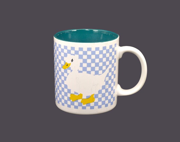 Pexim coffee or tea mug. White goose, yellow feet and beak on blue checkerboard ground. Made in Korea.