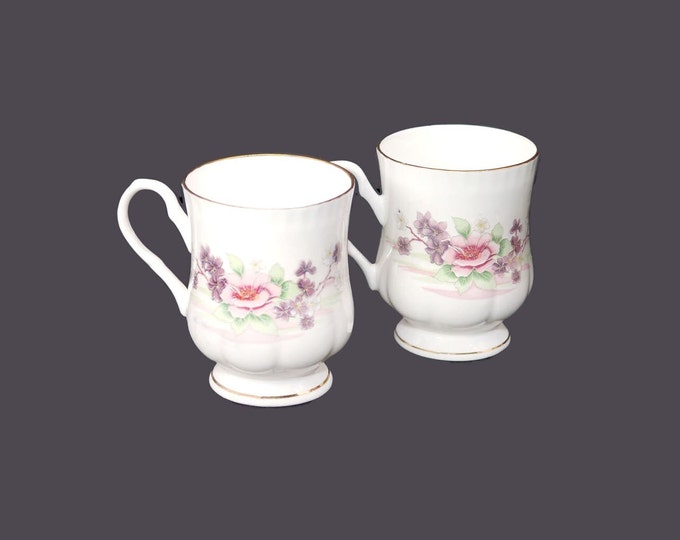 Pair of Crown Ceramics India bone china footed coffee | tea mugs. Pink and purple flowers, scalloped gold edge, accents.