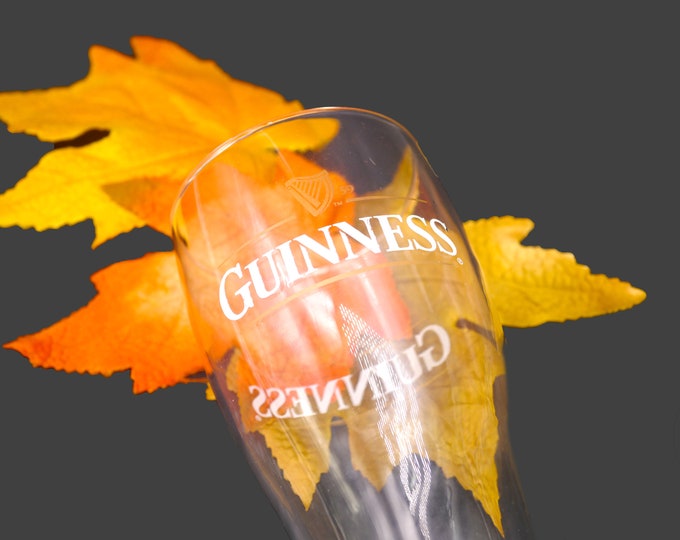 Guinness beer pint glass. Etched-glass branding. Guinness Harp on front.