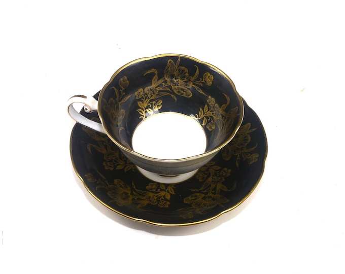Woodville China black and gold florals cup and saucer set. Bone china made in Japan. Minor flaw (see below).