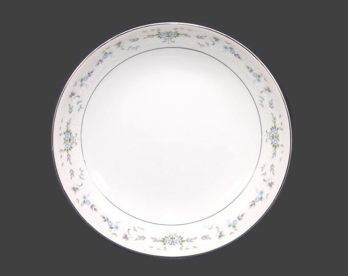 Sakura coupe soup bowl made in Japan. Small blue roses and white flowers, gray scrolls, platinum edge. Sold individually.