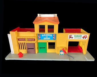 Fisher Price No. 6 Garage, Barber Shop, Police Station play set with convenient carry handle.