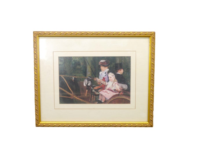 Framed print woman and young girl in horse-drawn carriage. Glass covered with gilt frame.
