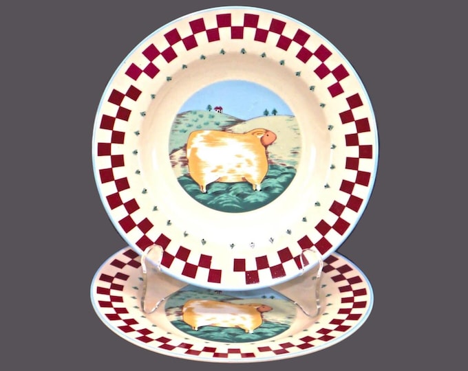 Pair of Tienshan Folk Art stoneware salad plates. Sheep in center, red checked rim, blue trim.