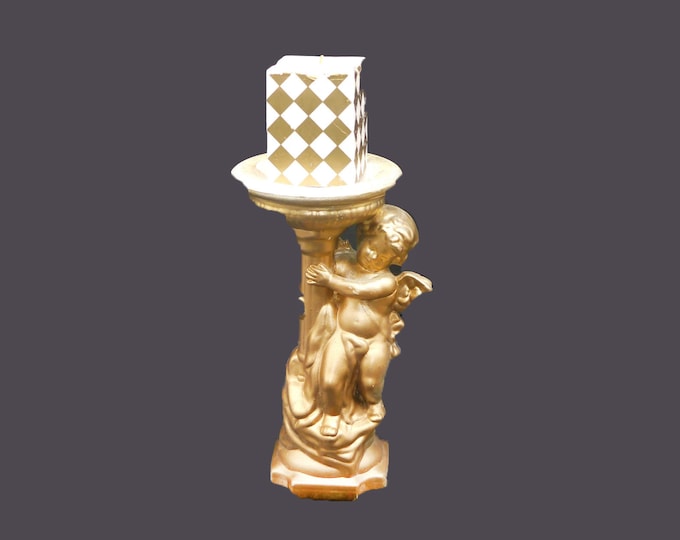 Gilded plaster paris cherub candle holder with square harlequin candle. Attributed 1980s.