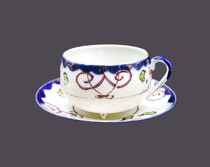 Art-deco era hand-painted Nippon moriage tea set (quad-footed cup with saucer). Cobalt, gold, maroon swirls, flowers.